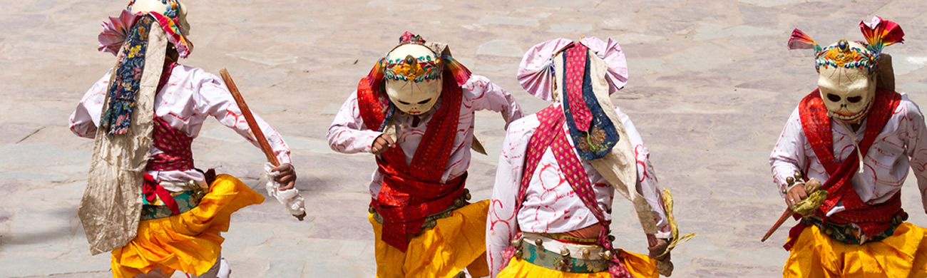 Monks performing a religious masked and costumed mystery dance of Tibetan Buddhism - Hemis Monastery, India.